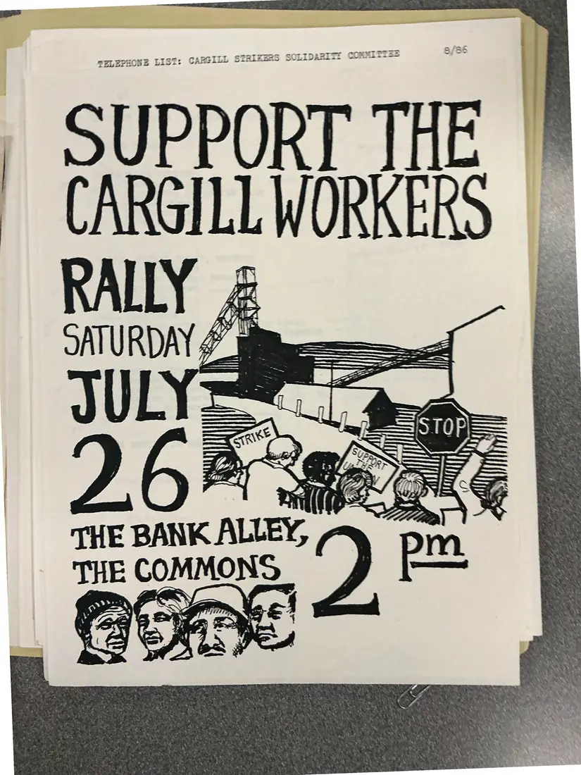Hand-drawn black-and-white flyer reading SUPPORT THE CARGILL WORKERS, RALLY SATURDAY JULY 26, THE BANK ALLEY, THE COMMONS, 2 PM, with drawings of a mine headframe, picket signs reading STRIKE and STOP, and faces of workers.