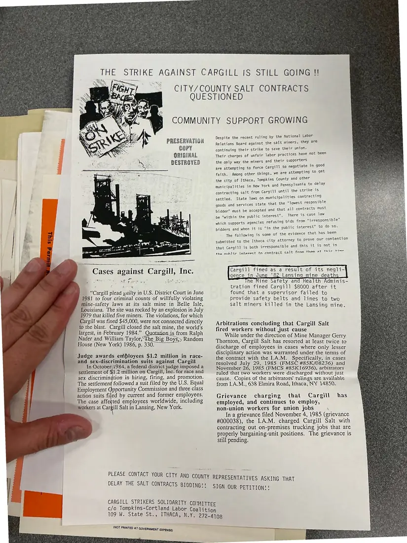 Photograph of a flyer: “The strike against Cargill is still going!!” flyer on city and county salt contracts, page 1.
