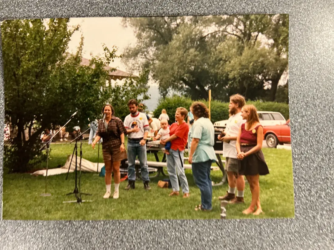 Color photograph: a second, slightly different print of people at picnic tables.