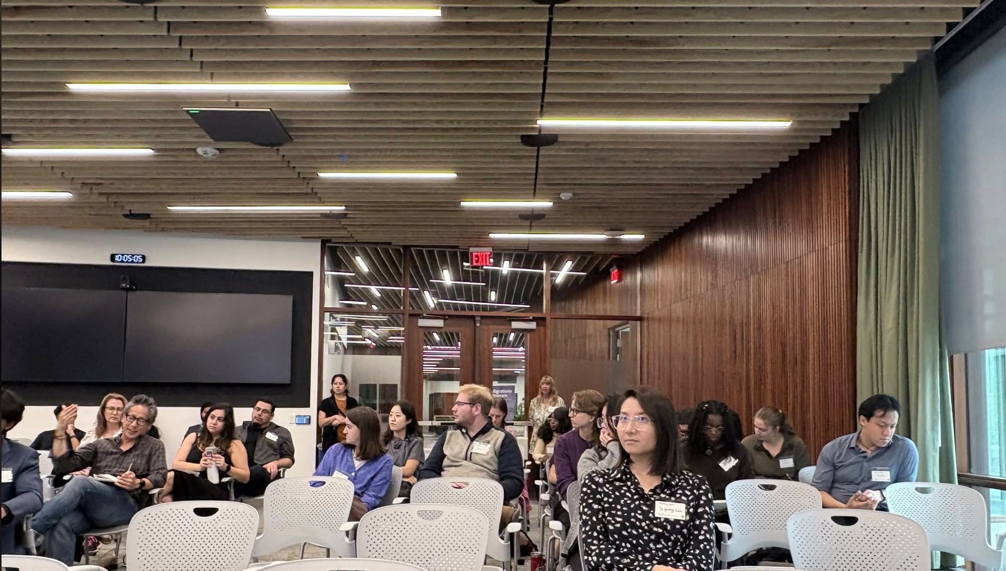 Conference attendees seated in Atkinson Hall during a session