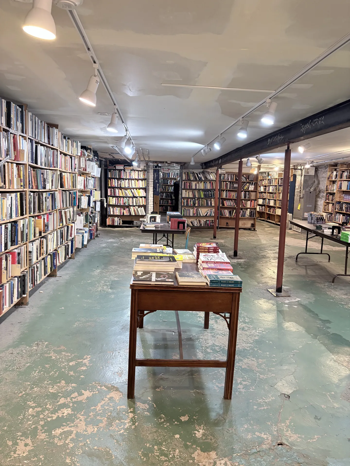 An independent bookshop lined with shelves and tables of books